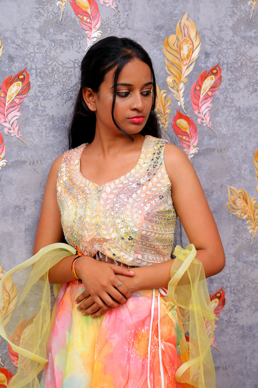 yellow and orange lehenga choli with a net dupatta
