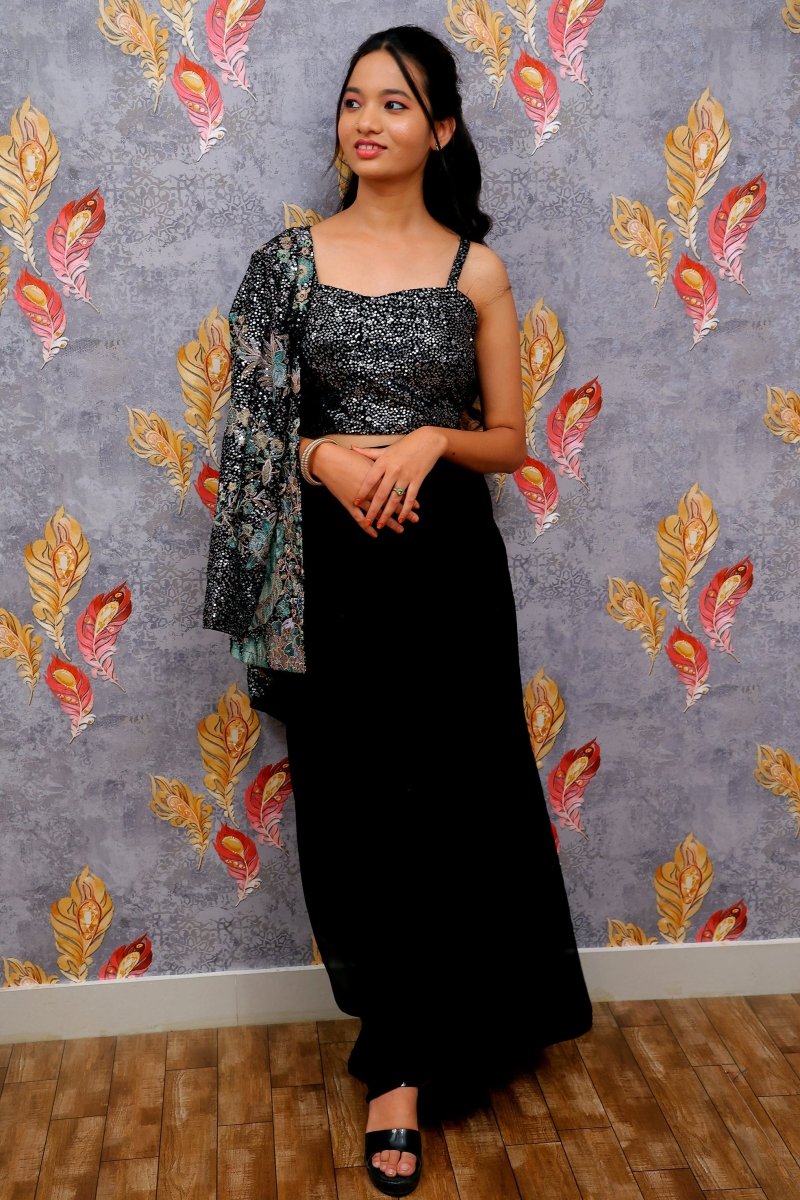 Black Draped Skirt Paired With A Sequined, Dark-Colored Crop Top And A Patterned Shrug For Women & Girls - Aira Fabrics Designer Studio