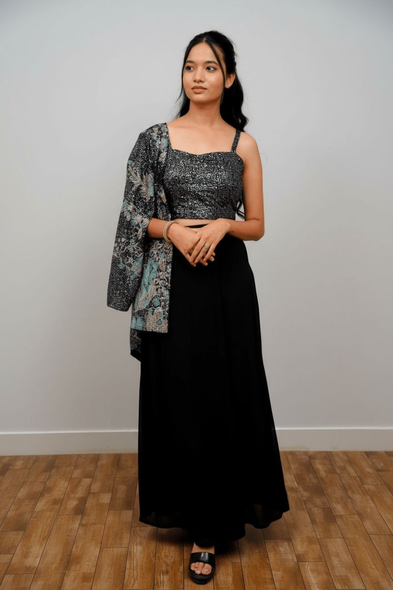 Black Draped Skirt Paired With A Sequined, Dark-Colored Crop Top And A Patterned Shrug For Women & Girls - Aira Fabrics Designer Studio